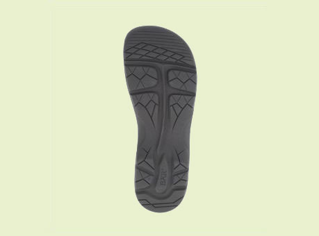 Image of a black shoe sole with intricate tread pattern, providing traction and comfort.