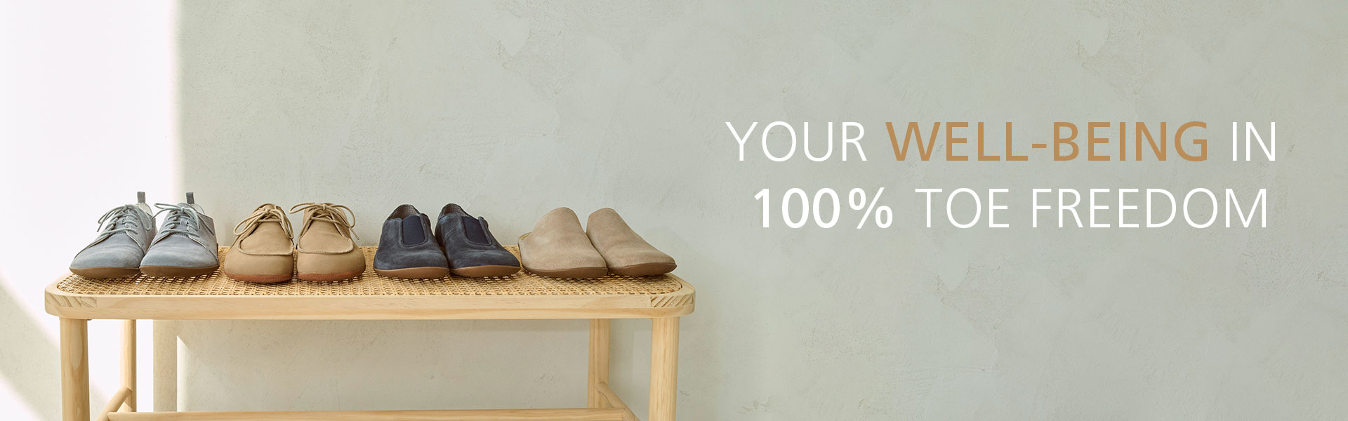 Four pairs of comfortable shoes on a wooden bench, promoting 100% toe freedom and well-being.