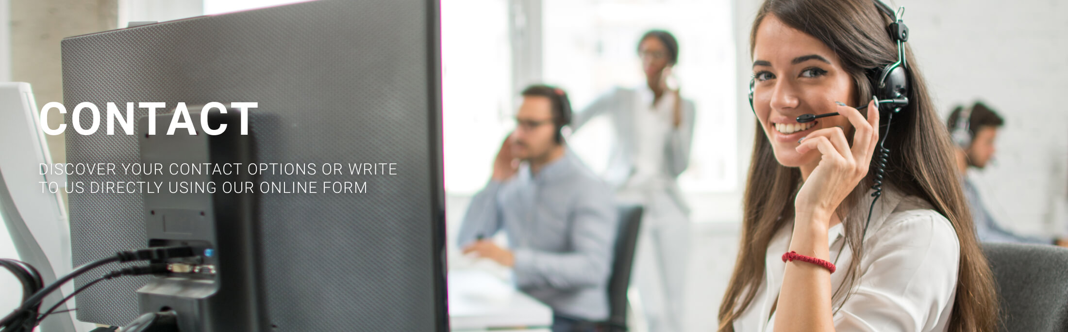 Smiling customer service representative wearing a headset in a modern office