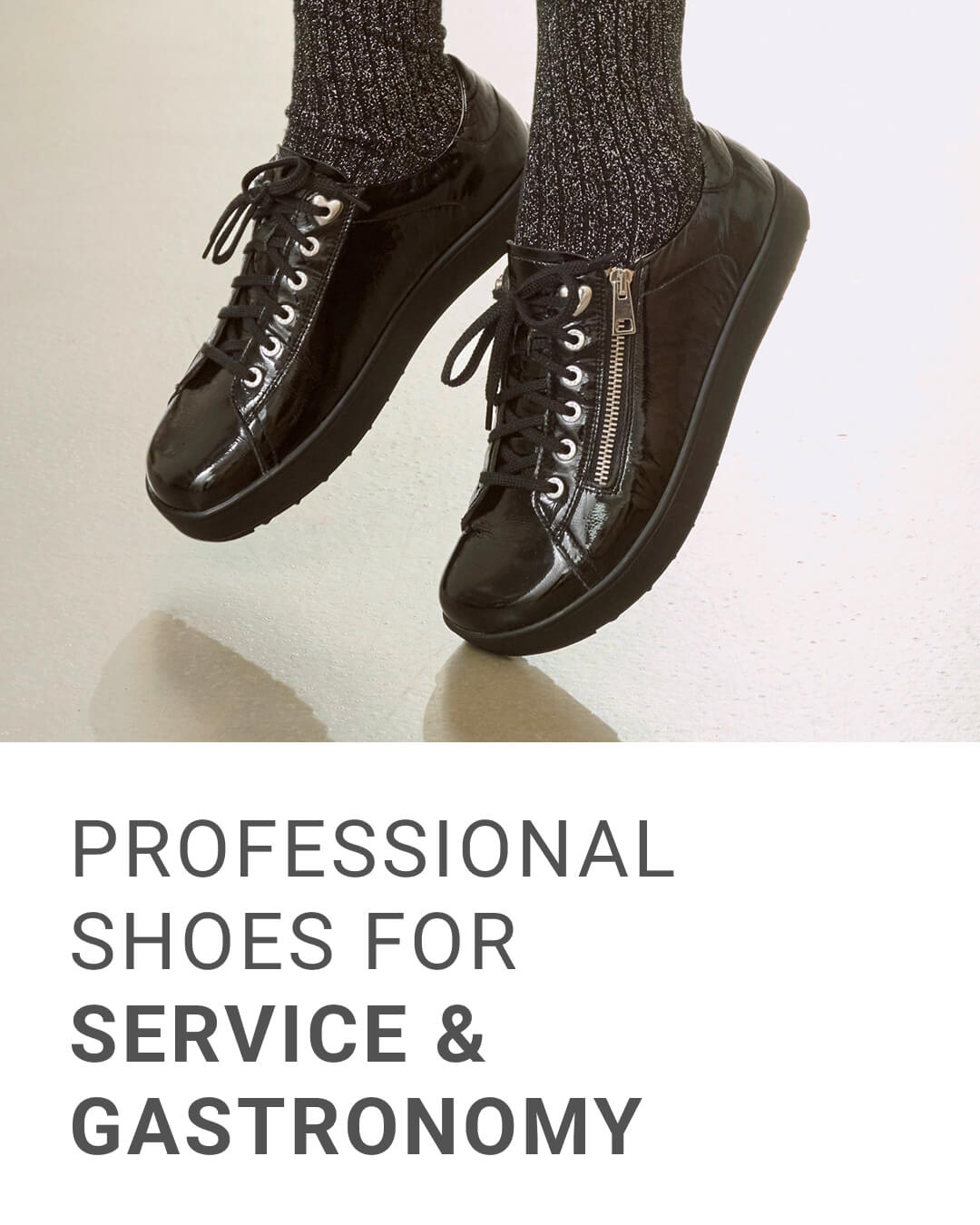 Black professional shoes designed for service and gastronomy, featuring zipper detail and worn with gray socks.
