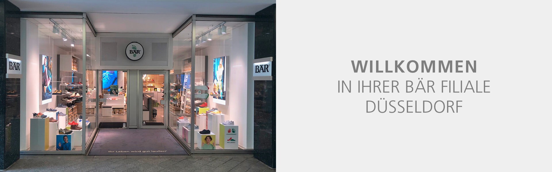 Entrance of BÄR shoe store in Düsseldorf with inviting display and welcome text