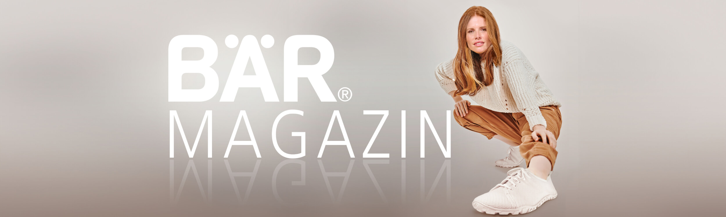Woman in casual attire crouching near BÄR Magazine logo