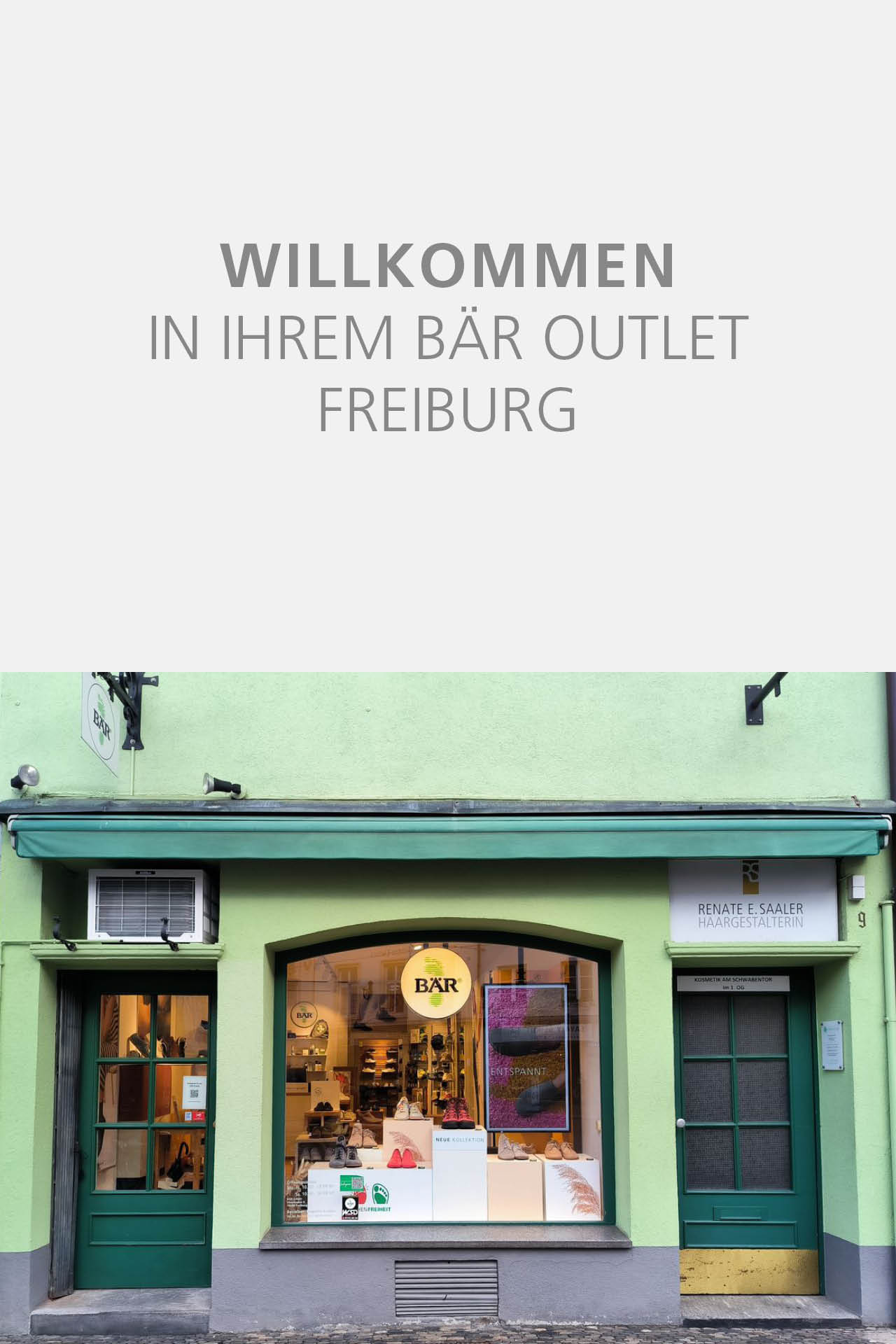 Front view of BÄR Outlet store in Freiburg, featuring a green facade with a display of shoes in the window.