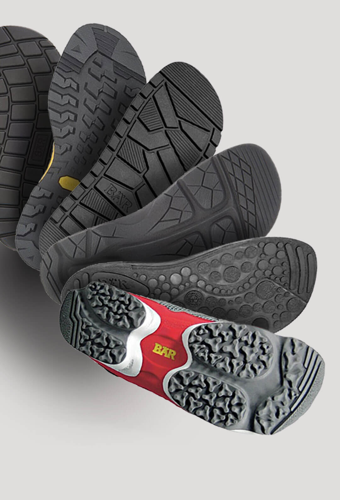 Close-up image of multiple shoe soles with different tread designs