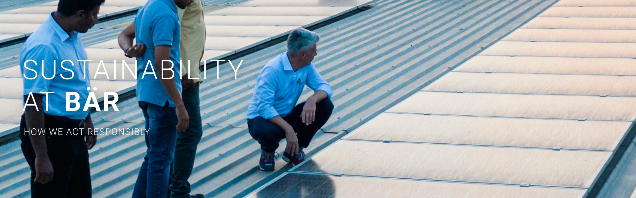 Men examining solar panels on a rooftop for sustainability efforts
