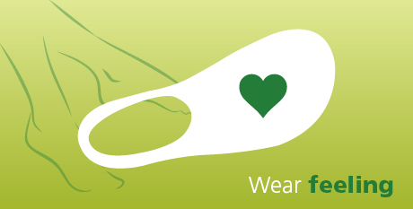 Illustration of a comfortable sock with a heart design, promoting the concept 'Wear Feeling' on a green background
