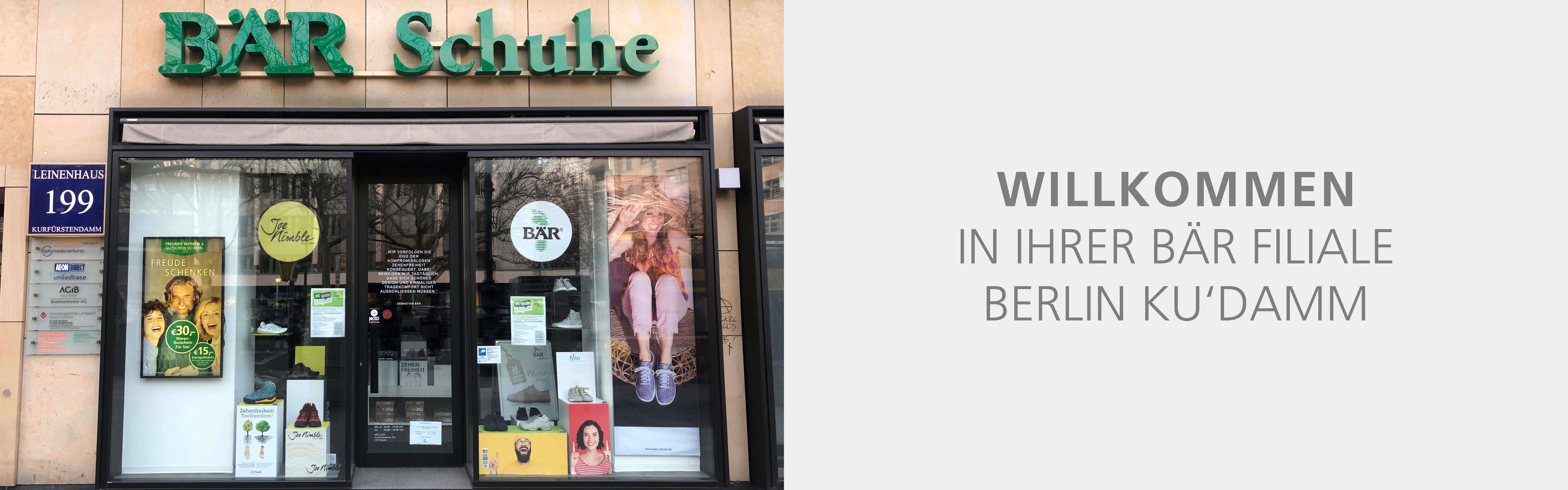 Exterior view of BÄR Shoes store on Kurfürstendamm in Berlin with promotional posters and shoe displays in the window.